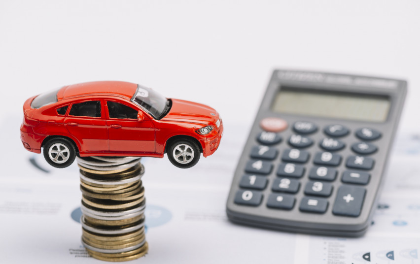 toy-car-coin-stack-with-calculator-report.jpg